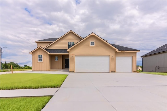 935 168th Ter, Basehor, KS 66007 - view of front of property with a garage, concrete driveway, board and batten siding, and a front lawn