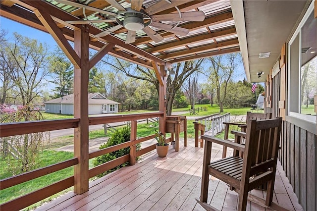 502 N Main St, Trimble, MO 64492 - wooden terrace featuring ceiling fan, a lawn, and view of scattered trees