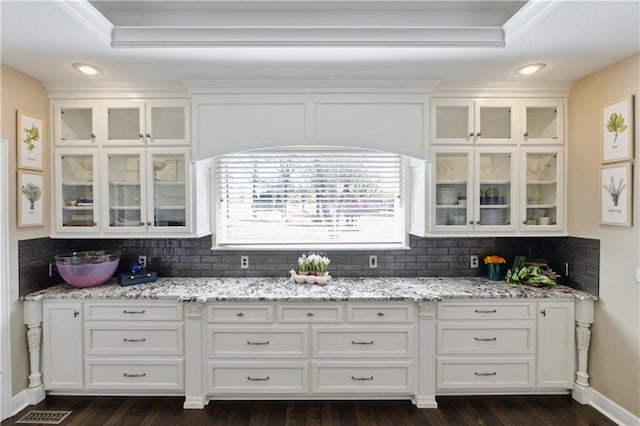 kitchen with white cabinets and tasteful backsplash