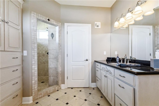 full bathroom with vanity, walk in shower, baseboards, tile patterned flooring, and visible vents