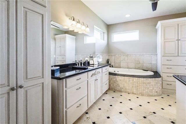 bathroom with a garden tub and vanity