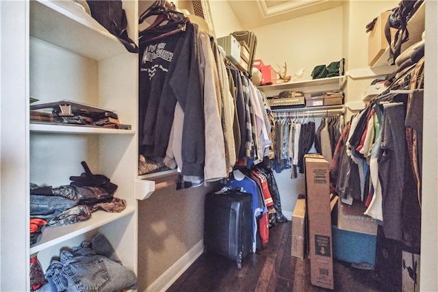 walk in closet with wood finished floors