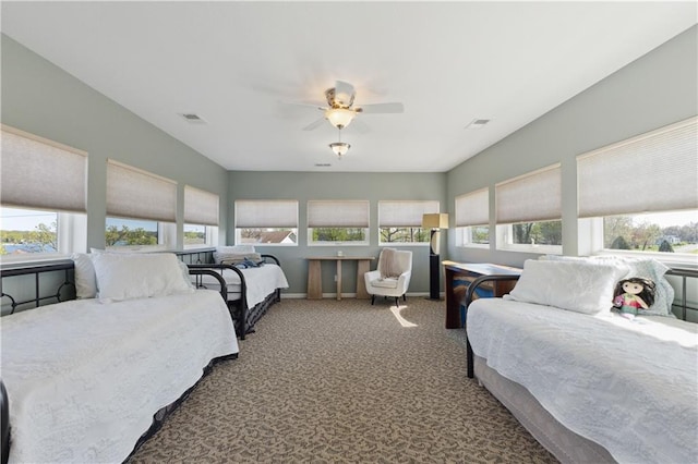 bedroom with a ceiling fan, multiple windows, visible vents, and carpet