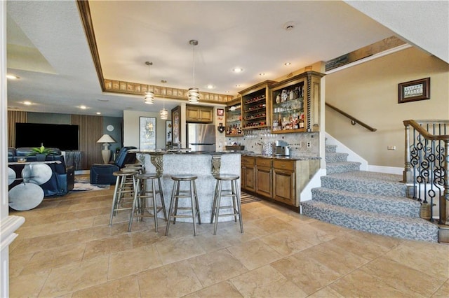 kitchen with open shelves, freestanding refrigerator, open floor plan, and brown cabinets