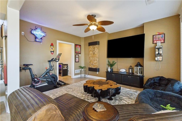 living area with visible vents, baseboards, and ceiling fan