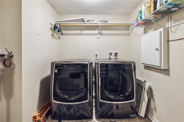 laundry room with washer and dryer, baseboards, and laundry area