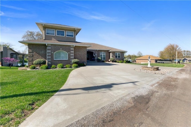 view of front facade with a front lawn and brick siding