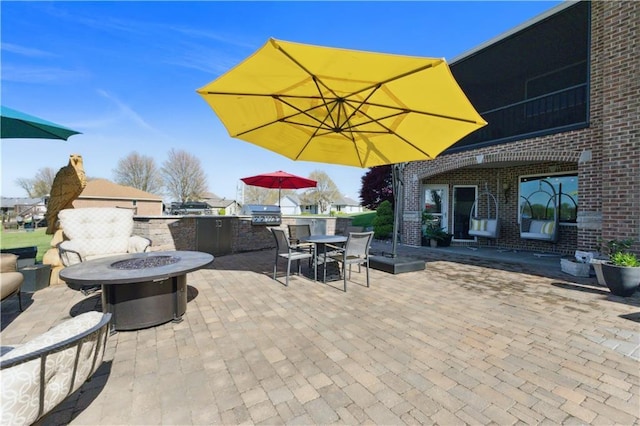 view of patio / terrace featuring grilling area, outdoor dining space, an outdoor fire pit, and area for grilling