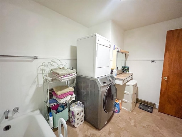1124 Pacific Ave, Osawatomie, KS 66064 - washroom with estacked washer and dryer