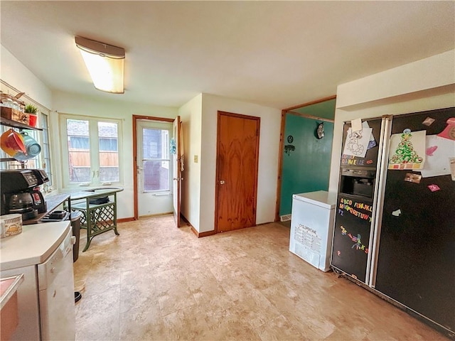 1124 Pacific Ave, Osawatomie, KS 66064 - kitchen featuring refrigerator with ice dispenser, light countertops, and fridge