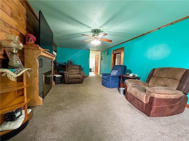 1124 Pacific Ave, Osawatomie, KS 66064 - carpeted living area with a fireplace and a ceiling fan