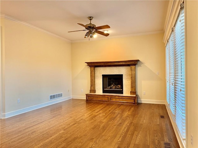 14413 Stearns St, Overland Park, KS 66211 - unfurnished living room with wood finished floors, ceiling fan, ornamental molding, baseboards, and a tile fireplace