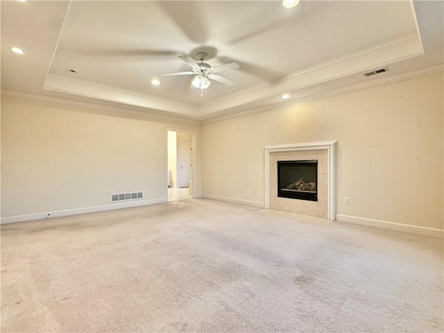 14413 Stearns St, Overland Park, KS 66211 - unfurnished living room featuring a tray ceiling, crown molding, ceiling fan, a tile fireplace, and recessed lighting