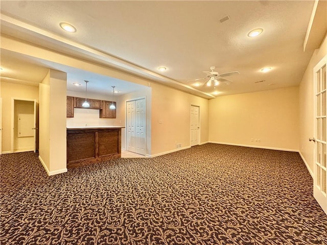 14413 Stearns St, Overland Park, KS 66211 - unfurnished living room featuring dark colored carpet, baseboards, recessed lighting, a ceiling fan, and bar area