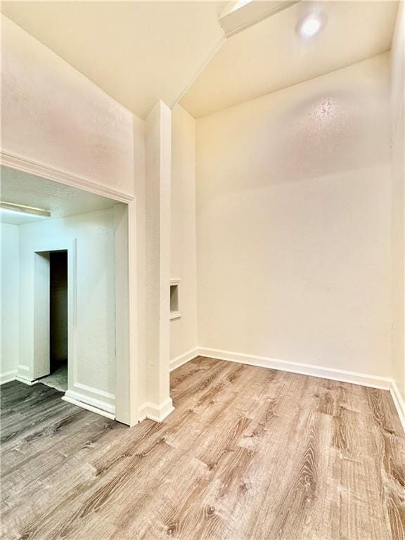 14413 Stearns St, Overland Park, KS 66211 - unfurnished room featuring wood finished floors, baseboards, and lofted ceiling