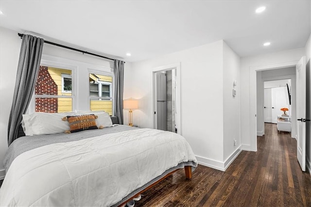 5933 Rockhill Rd, Kansas City, MO 64110 - bedroom featuring baseboards, wood finished floors, and recessed lighting