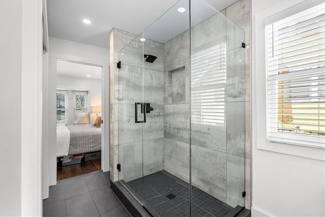 5933 Rockhill Rd, Kansas City, MO 64110 - ensuite bathroom featuring tile patterned flooring, a shower stall, and recessed lighting