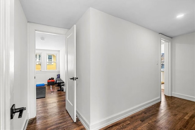 5933 Rockhill Rd, Kansas City, MO 64110 - hallway featuring dark wood-style floors, healthy amount of natural light, and baseboards