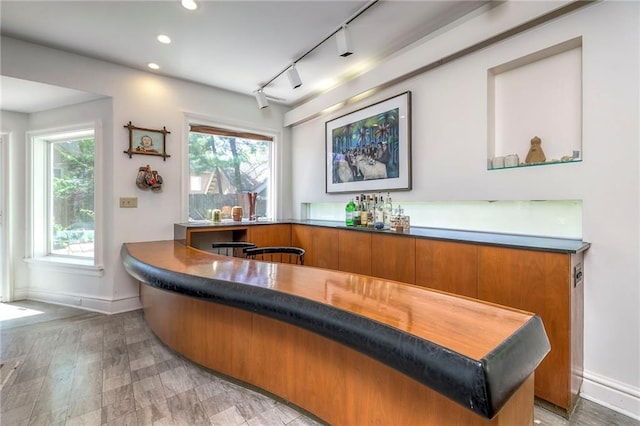 bar with track lighting, baseboards, and recessed lighting