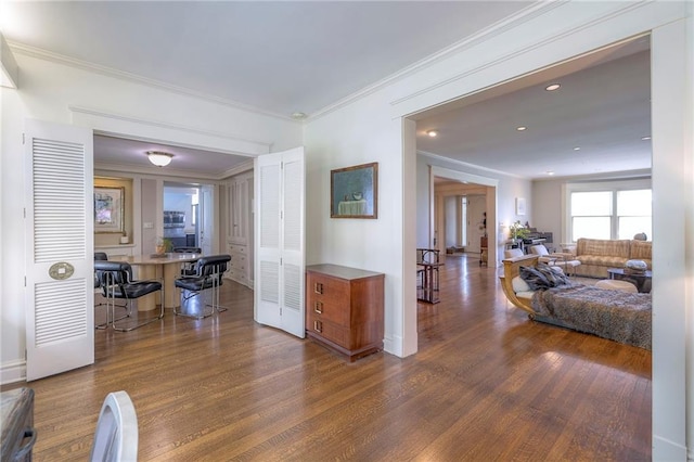hall with baseboards, ornamental molding, and dark wood-type flooring