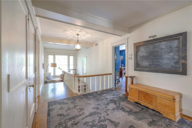 hall featuring crown molding, beamed ceiling, an upstairs landing, and wood finished floors