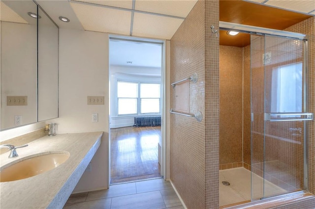 bathroom featuring a sink, tile patterned flooring, and a shower stall