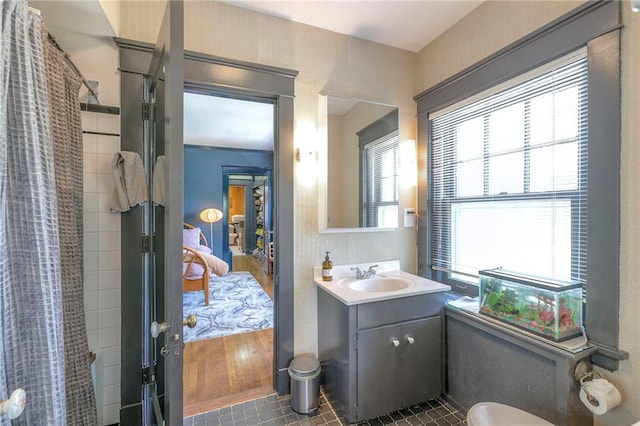 full bath with vanity, a shower with shower curtain, and connected bathroom