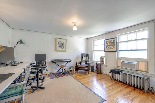 home office featuring radiator heating unit and hardwood / wood-style floors