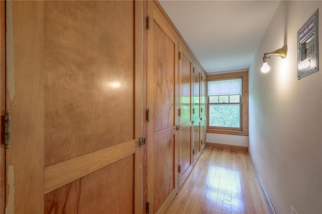 hallway with baseboards and light wood finished floors