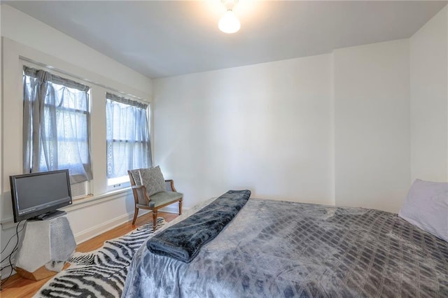 bedroom with baseboards and light wood-style flooring