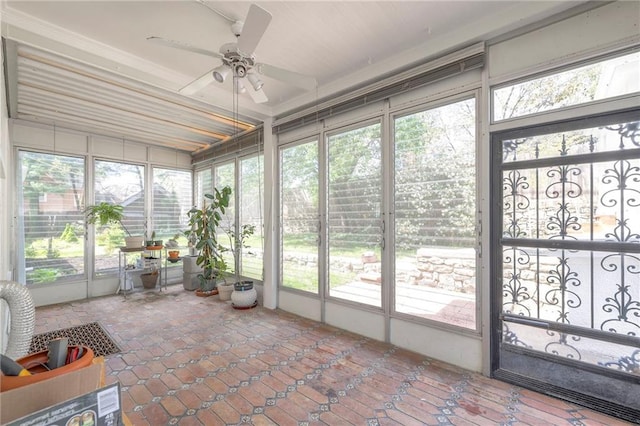 unfurnished sunroom with plenty of natural light and ceiling fan