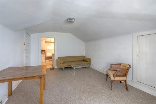 unfurnished room with carpet and lofted ceiling