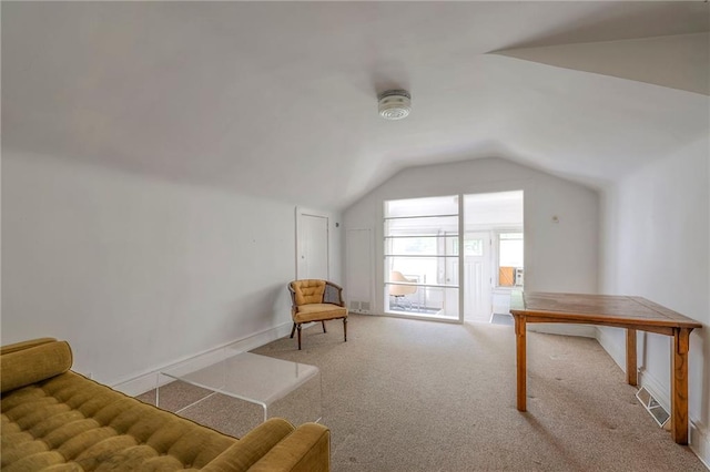 sitting room with carpet floors, baseboards, and lofted ceiling