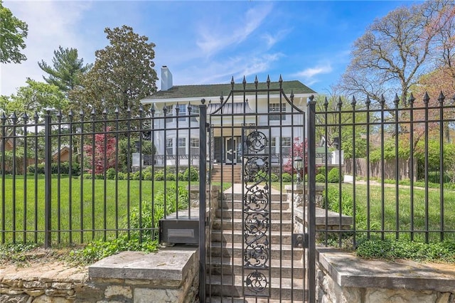 view of gate featuring a lawn and fence private yard