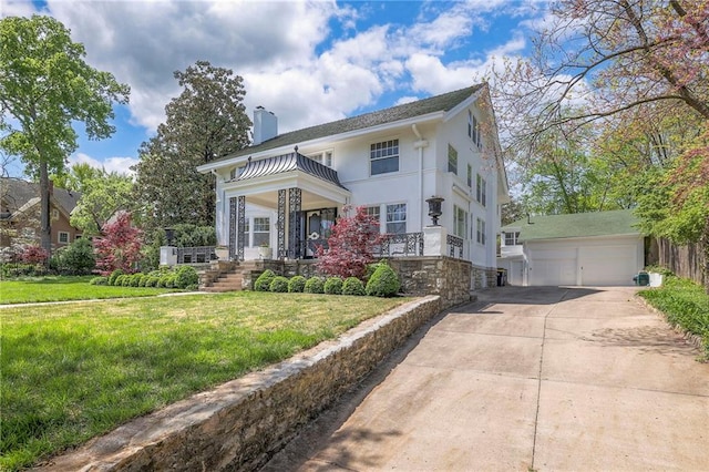 view of front facade featuring an outdoor structure, covered porch, a front yard, stone siding, and a chimney