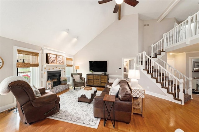 17014 NE 119th St, Kearney, MO 64060 - living area featuring high vaulted ceiling, ceiling fan, stairway, wood finished floors, and beam ceiling