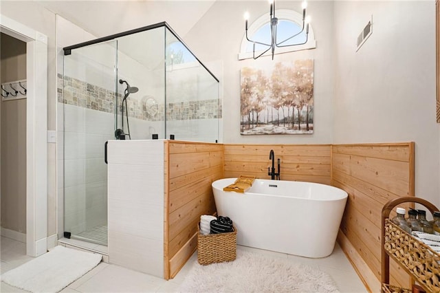 17014 NE 119th St, Kearney, MO 64060 - full bathroom featuring a stall shower, a freestanding tub, wooden walls, and tile patterned flooring