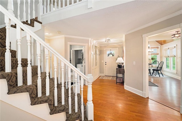 17014 NE 119th St, Kearney, MO 64060 - stairway with wood finished floors, washer / clothes dryer, ornamental molding, and baseboards