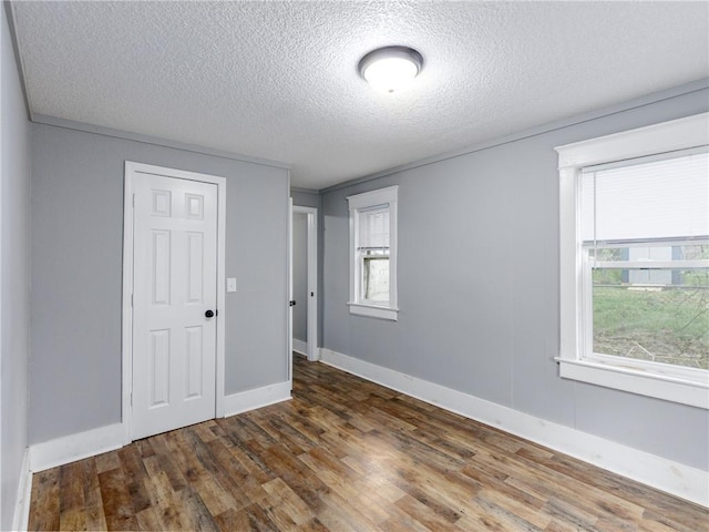 3931 Norledge Ave, Kansas City, MO 64123 - unfurnished room with a textured ceiling, baseboards, and wood finished floors