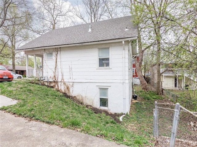 3931 Norledge Ave, Kansas City, MO 64123 - view of home's exterior with fence and roof with shingles