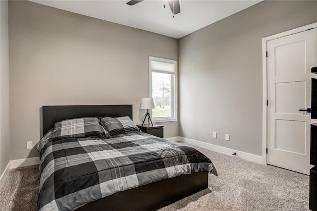 carpeted bedroom featuring baseboards and ceiling fan