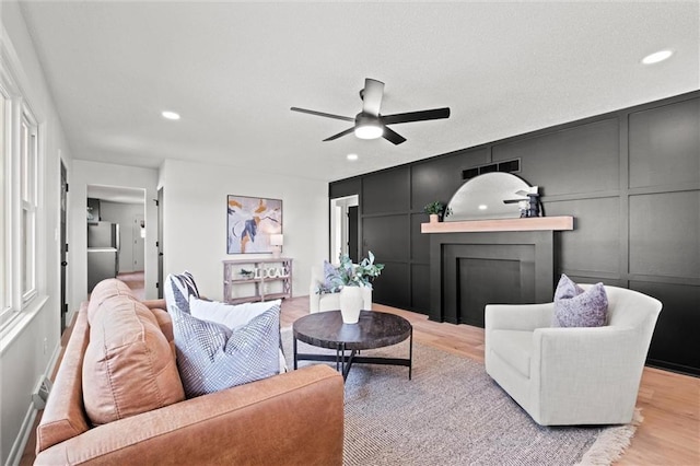 14875 Edgerton Rd, Gardner, KS 66030 - living room with light wood-type flooring, a ceiling fan, a decorative wall, and recessed lighting