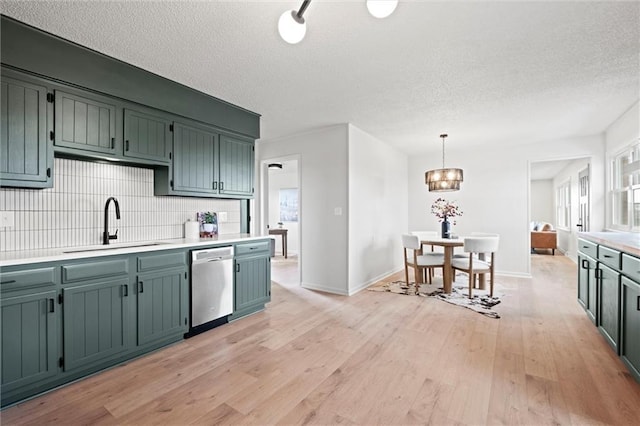 14875 Edgerton Rd, Gardner, KS 66030 - kitchen with dishwasher, a textured ceiling, light wood-type flooring, tasteful backsplash, and a chandelier