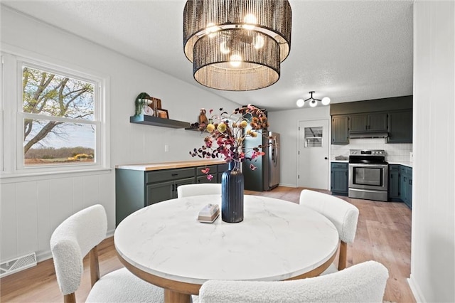 14875 Edgerton Rd, Gardner, KS 66030 - dining space featuring light wood-type flooring and a chandelier