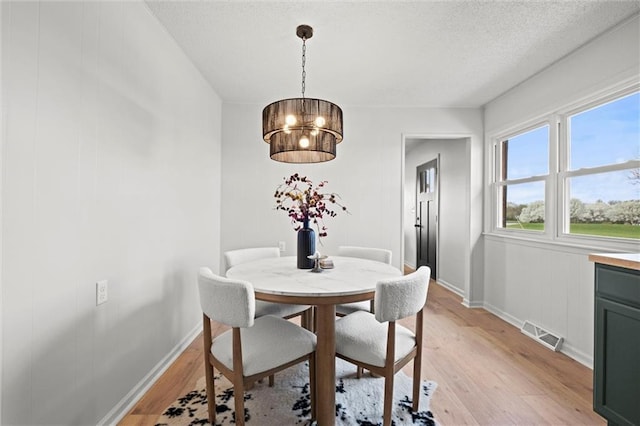 14875 Edgerton Rd, Gardner, KS 66030 - dining area featuring light wood finished floors and a textured ceiling