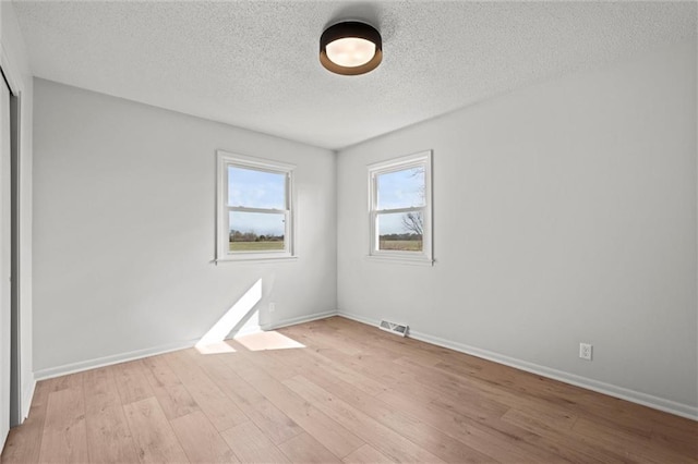 14875 Edgerton Rd, Gardner, KS 66030 - empty room featuring a textured ceiling and light wood-style floors