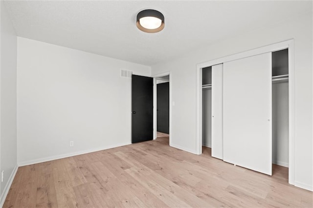 14875 Edgerton Rd, Gardner, KS 66030 - unfurnished bedroom with light wood finished floors and a closet