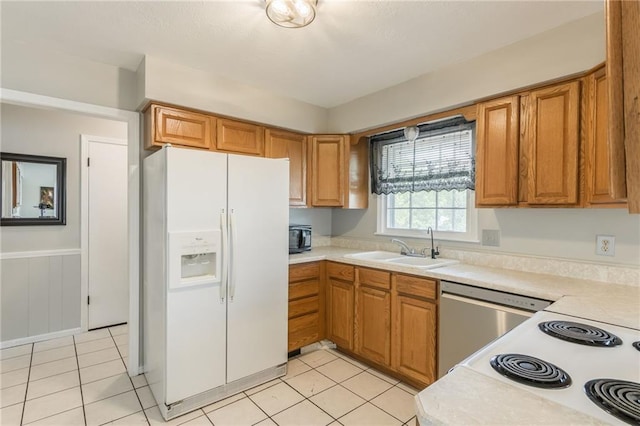 7201 E 130th Ter, Grandview, MO 64030 - kitchen with white fridge with ice dispenser, light countertops, dishwasher, and light tile patterned floors