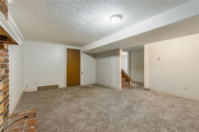 7201 E 130th Ter, Grandview, MO 64030 - finished basement featuring a textured ceiling, carpet, and stairway