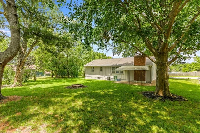 7201 E 130th Ter, Grandview, MO 64030 - view of grassy yard with a fire pit